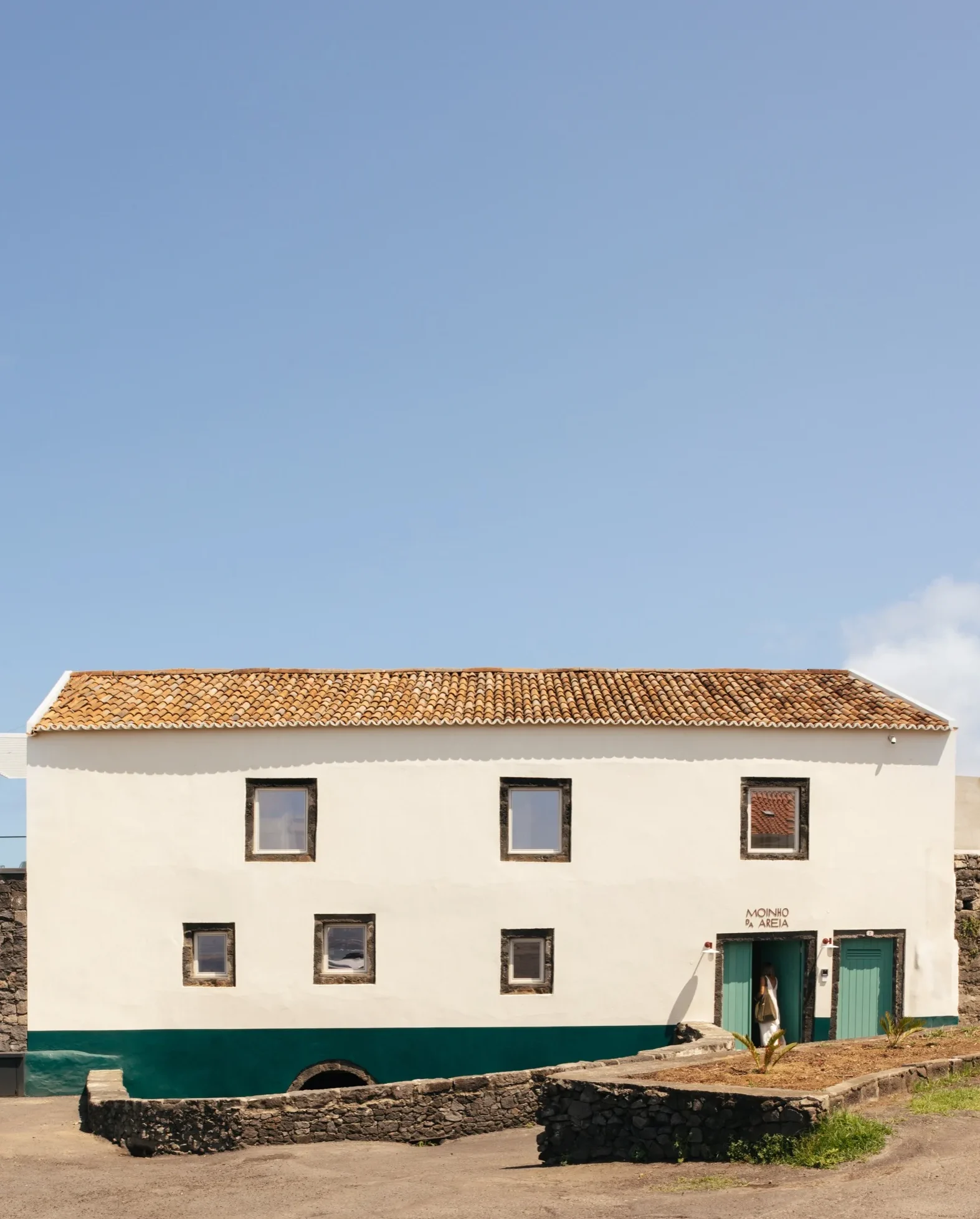 The facade of Moinho da Areia, a beachfront boutique hotel in Azores